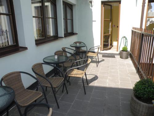 a row of tables and chairs on a patio at Penzion Bludička in Litomyšl