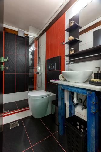 a bathroom with a toilet and a sink at Villa Menelaos in Mochlos