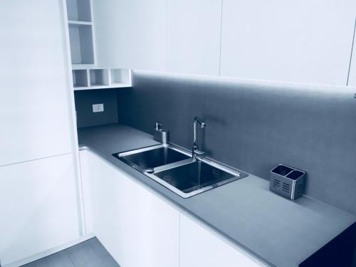 a kitchen with a sink in a white kitchen at Vacanze in Puglia Conversano in Conversano
