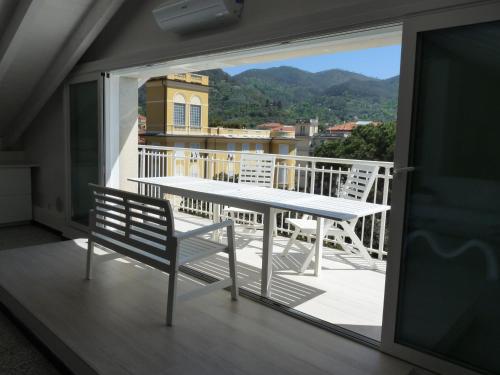 a table and chairs on a balcony with a view at Penthouse by the Sea in Levanto