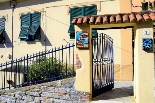a gate in front of a building with green shutters at Levante Blu in La Spezia