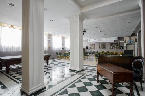 a lobby with columns and tables and chairs at Hotel Residenza In Farnese in Rome
