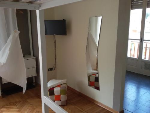 a room with a mirror and a tv on the wall at Sei Da Noi in Ivrea