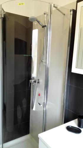 a shower with a glass door in a bathroom at Albergo Casa Este in Brenzone sul Garda