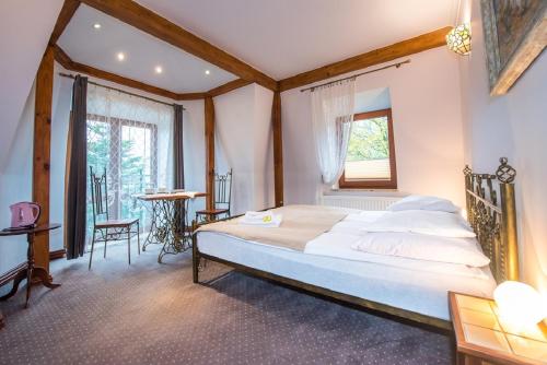 a bedroom with a large bed and a window at Villa Akacja in Łeba