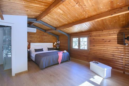a bedroom with a bed in a wooden cabin at Hotel Convent de Begur in Begur