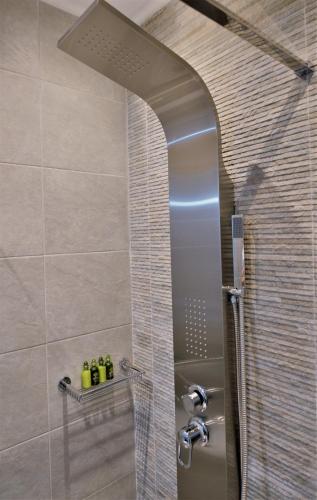 a bathroom with a shower with a glass door at Athens Riviera Loft in Athens