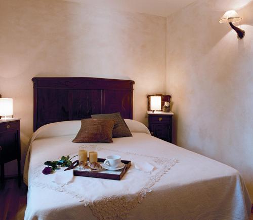a bedroom with a bed with a tray of food on it at Apartaments Boutique la Torreta del Llac in Puigcerdà