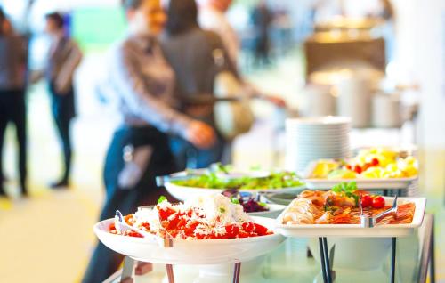 a buffet with several plates of food on display at Elba Vecindario Aeropuerto Business & Convention Hotel in Vecindario