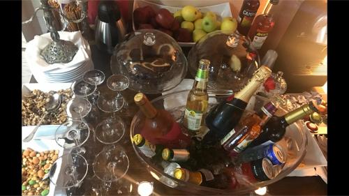 a table topped with glasses of wine and wine bottles at Art 'Otel in Sofia