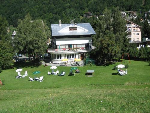 a large building with a lot of chairs in a field at Albergo Cioccarelli in Aprica