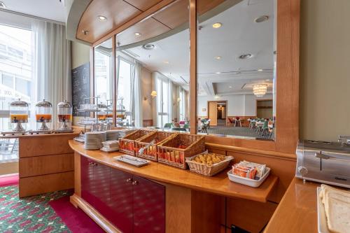 a restaurant with a counter with baskets of food at Trip Inn Frankfurt Nordwestzentrum in Frankfurt/Main