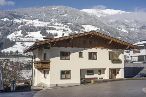 a house with a view of a snowy mountain at Apartment Aschenwald Elisabeth in Ramsau im Zillertal