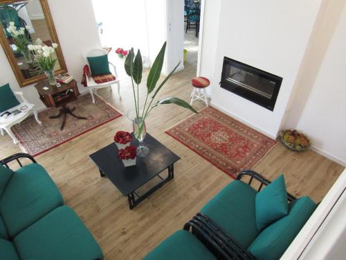 a living room with a couch and a table and a tv at Arenosu Comfort Country Guesthouse in Fertilia