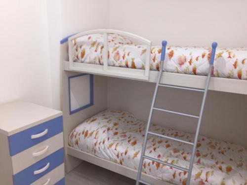 a bedroom with two bunk beds and a desk at Rosa Dei Venti in Valledoria