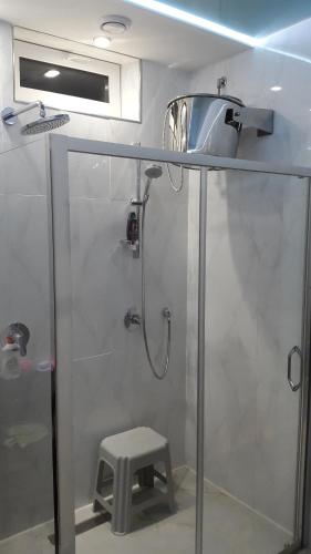 a shower with a sink and a stool in a bathroom at Park Puscha Sauna Deluxe Apartment & Terrace in Kyiv