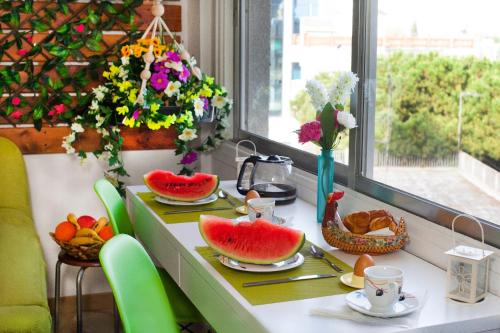 a table with fruit on it in a room with a window at Artemis Boutique Apartment 1 in Limassol