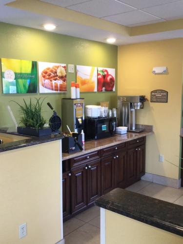 a kitchen with a counter with a coffee maker at Quality Inn & Suites Glenmont - Albany South in Glenmont