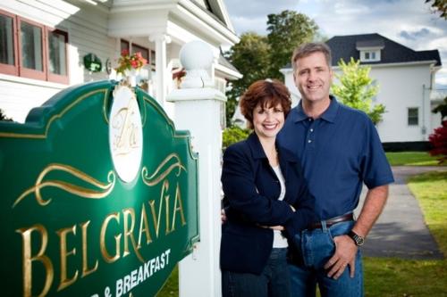 a man and a woman standing next to a sign at Belgravia B&B in Truro