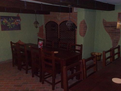 a dining room with a wooden table and chairs at Ubytovani U Kulky in Kyjov