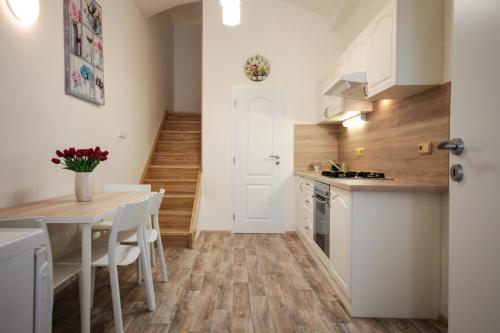 a kitchen and dining room with a table and chairs at Family Duplex on Wenceslas square in Prague