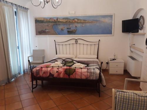 a bedroom with a bed and a painting on the wall at CETARA - ALBERGO DIFFUSO in Cetara