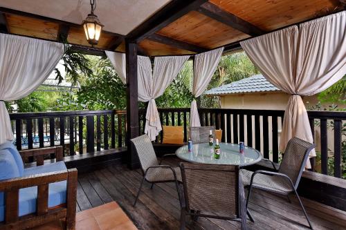 a patio with a table and chairs on a deck at Eden's Boutique in Had Nes