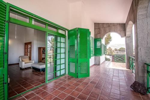 a living room with green doors and a couch at Vista Timanfaya in Yaiza