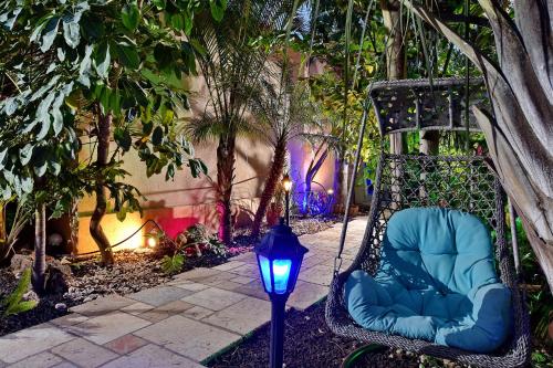 a blue chair with a light in a garden at Eden's Boutique in Had Nes