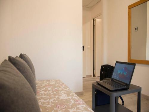 a laptop computer sitting on a table on a bed at Infinity in Cervia