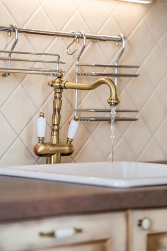 a bathroom sink with water coming from a faucet at Apartments Villa Nora in Rijeka