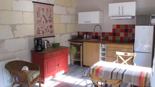 a kitchen with a red cabinet and a red stove at La cordonnerie in Loches