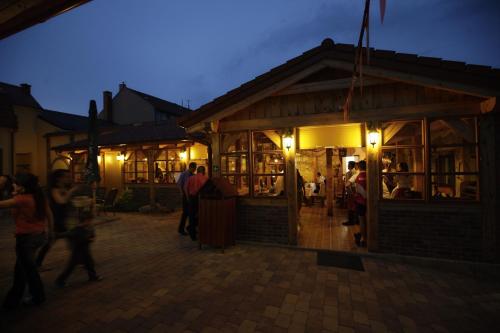 a group of people standing outside a restaurant at night at Ubytovani U Kulky in Kyjov
