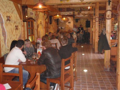 a group of people sitting at a table in a restaurant at Ubytovani U Kulky in Kyjov