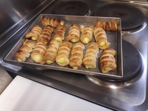 a tray of croissants and other food in an oven at Agriturismo Al Navile in Malalbergo