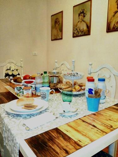 a table topped with plates and bowls of food at Villa dei Pescatori in LʼAquila