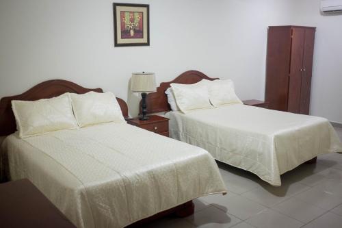 Postel nebo postele na pokoji v ubytování Hotel Latino