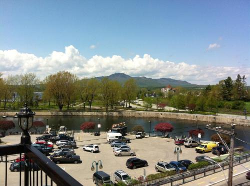 a parking lot with cars parked next to a bridge at Auberge du Grand Lac in Magog-Orford