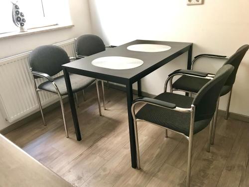 a black table and chairs in a room at House-In Apartments - Free Parking - WiFi - Kitchen in Essen