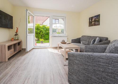 a living room with a couch and a table at Spreewaldapartments-Kossatz in Lübben