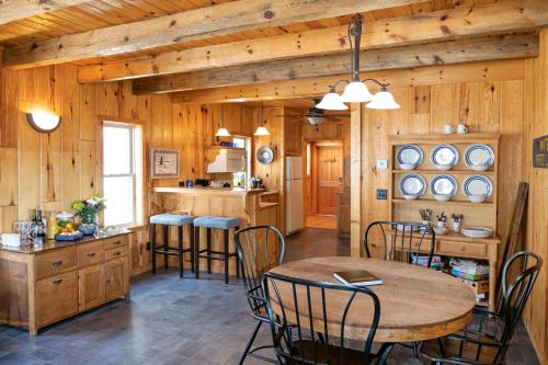 a kitchen with wooden walls and a table and chairs at A Stay Inn Ely in Ely