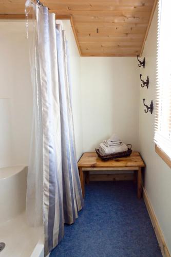 a room with a wooden bench and a window at Stay Inn Ely in Ely