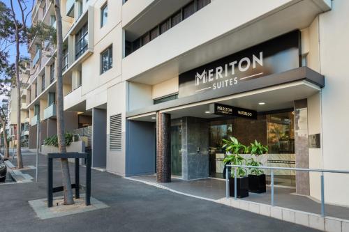 a store front with a sign for the merion suites at Meriton Suites Waterloo in Sydney