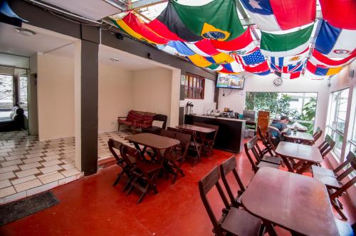 a restaurant with tables and chairs and colorful umbrellas at Casa Machu Picchu Hostel in Machu Picchu