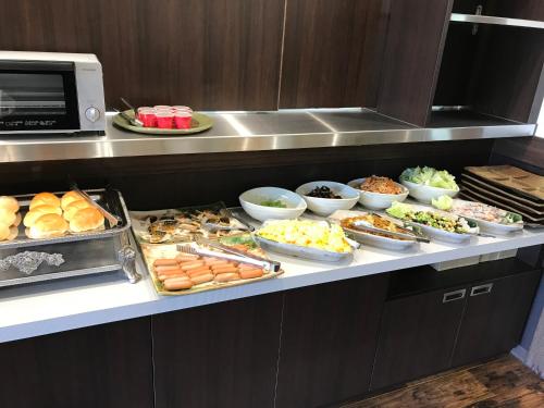a buffet line with many different types of food at Hotel Famitic Nikko Station in Nikko