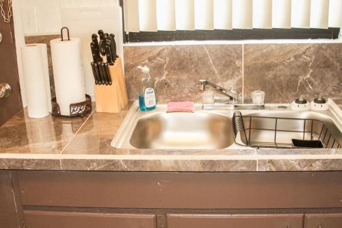 a kitchen counter with a sink in a kitchen at 2 BEDROOM / 1 BATH ONLY 5 MINUTES AWAY FROM BANK OF HAWAII in Sinajana