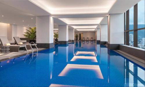 a swimming pool in a hotel with a view of the city at Summit Galleria Cebu in Cebu City