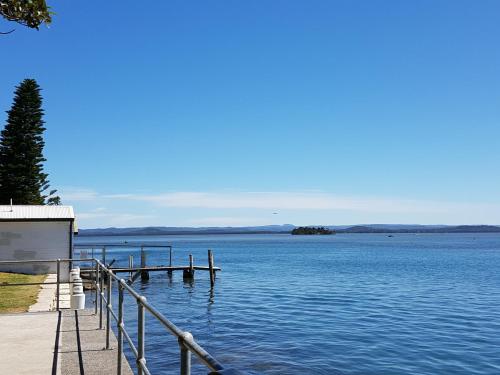 a dock on a body of water at The Entrance Backpackers in The Entrance