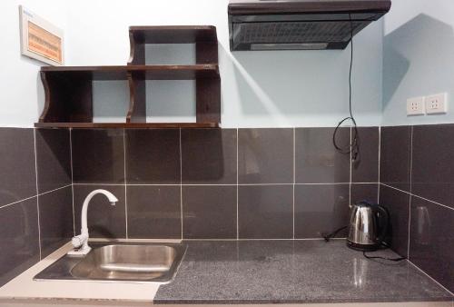 a kitchen counter with a sink and a toaster at Crowne Garden Hotel in Cebu City