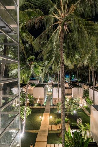 a palm tree in the middle of a building at Svarga Resort Lombok in Senggigi 